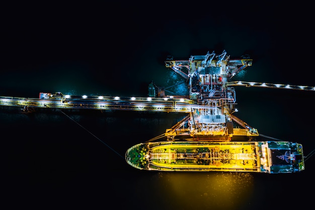 Night shot oil tanker shipping loading in oil station import and export  logistics transportation business top view 