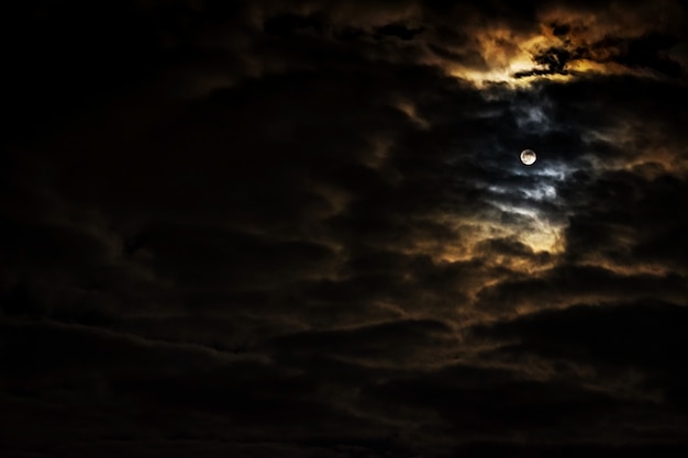 Cielo notturno con la luna piena e belle nuvole.