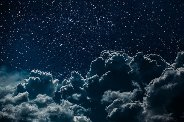 Photo night sky with stars and moon and clouds.