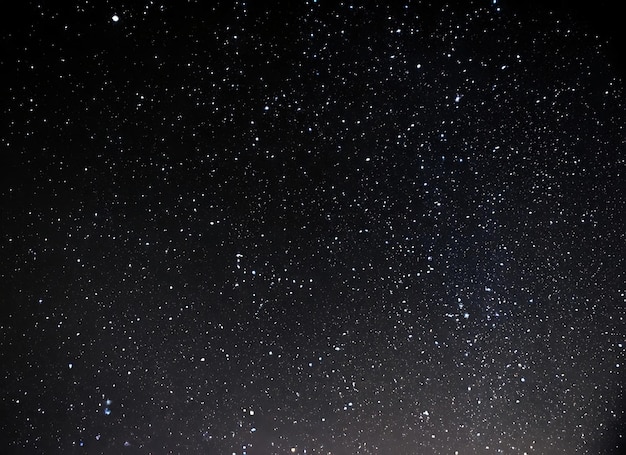 Night sky with stars sparkling on black background