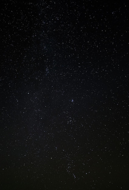 The night starry sky, a dark outer space with nebulae and constellations