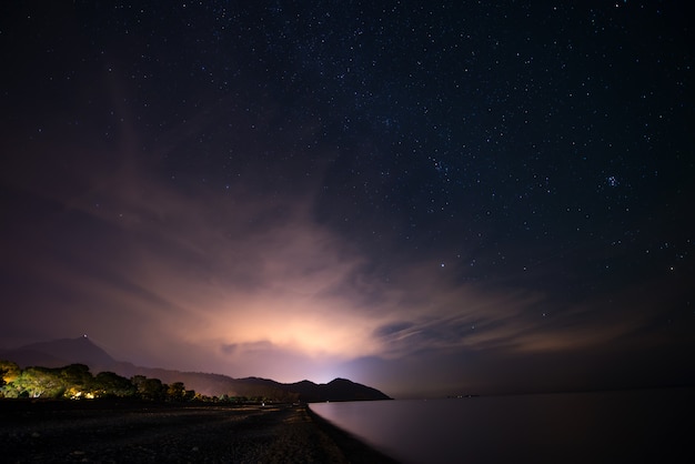 Night starry sky at the sea coast 