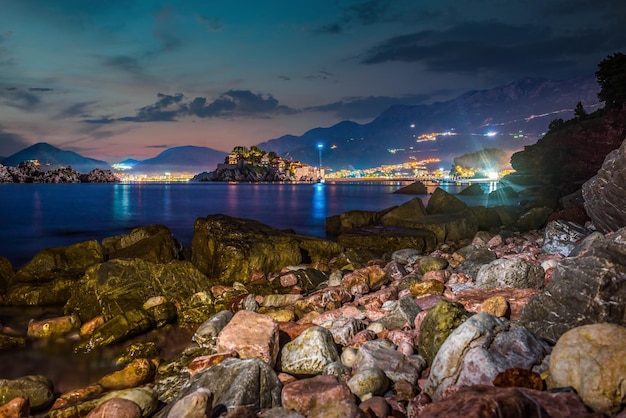 Night over stony sea shore in Sveti Stefan, Montenegro