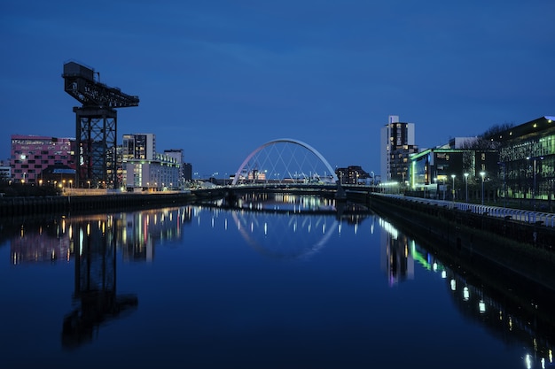 Night view of the Clyde Arc or Squinty Bridge from the East and river Clyde, Glasgow, Scotland