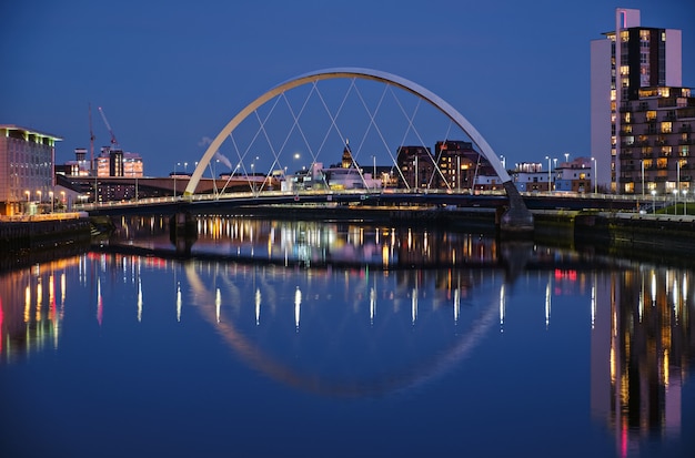 Night view of the Clyde Arc or Squinty Bridge and the River Clyde, Glasgow, Scotland