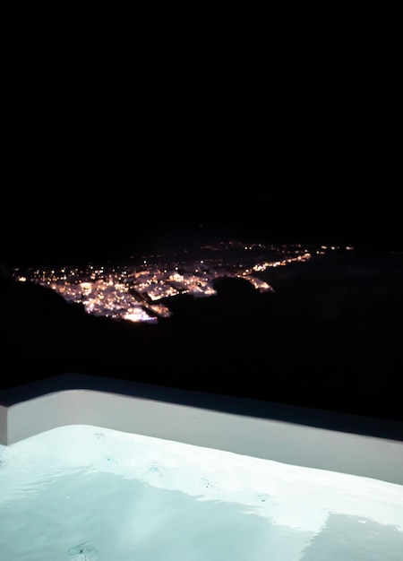 Night view of Fira, from a private pool in Imerovigli, Santorini