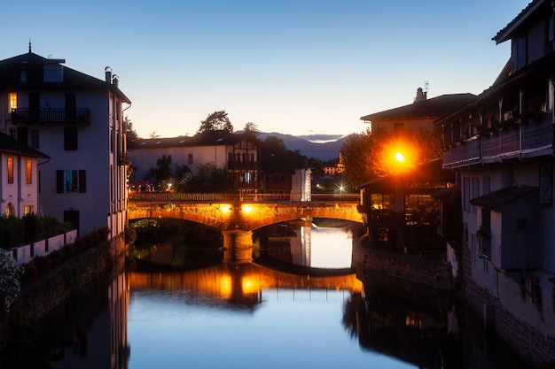 Night view of the historic bridge on the Nive River Saint Jean Pied de Port France