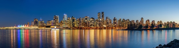 Night view of Vancouver downtown skyline panorama after sunset Colorful buildings lights reflections