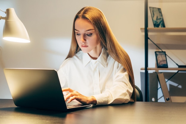 Night work remote job woman using laptop