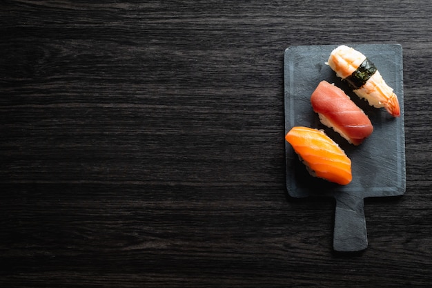 Foto sushi di nigiri sulla tavola di legno in un ristorante giapponese. copyspace e vista dall'alto