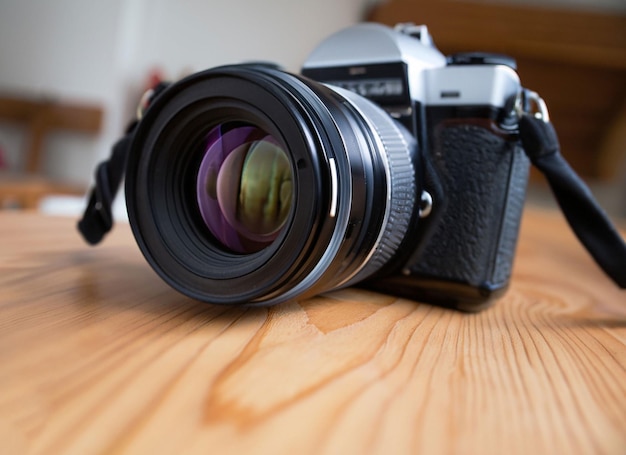 A nikon camera is sitting on a wooden table.