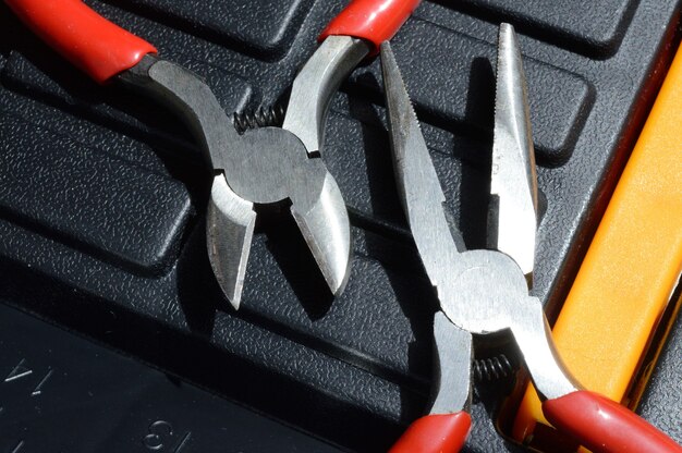 Nippers and side cutters are on the tool box. close-up.