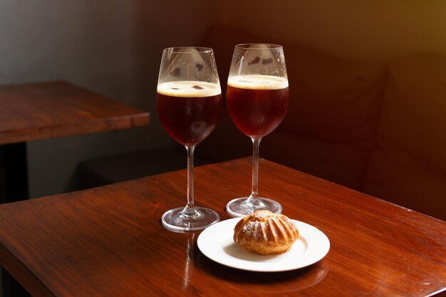 Nitro cold brew coffee drink with ice in coffee shop cafe, alternative coffee, v60, profiterole.