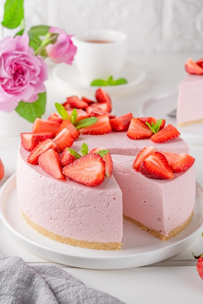 No bake cheesecake with fresh strawberries on a white wooden background Summer dessert