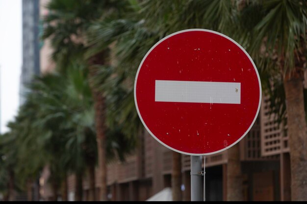 Photo no entry road sign the road is closed red round sign white brick in red circle road sign