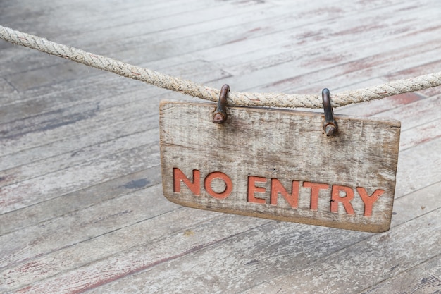 No Entry wood sign with old rope on old wood background