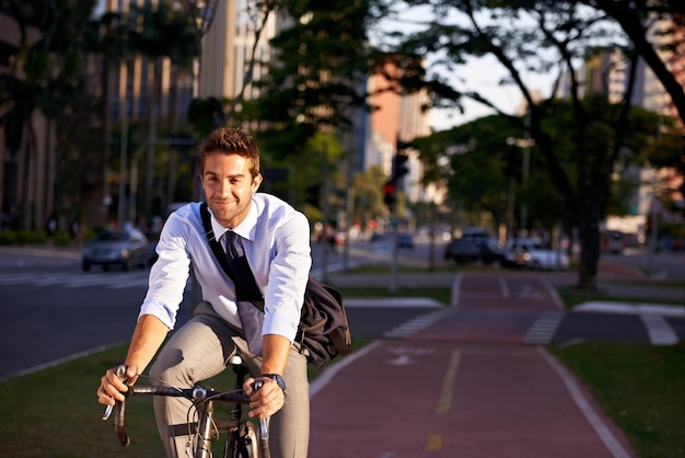 No gym membership needed Shot of a businessman commuting to work with his bicycle