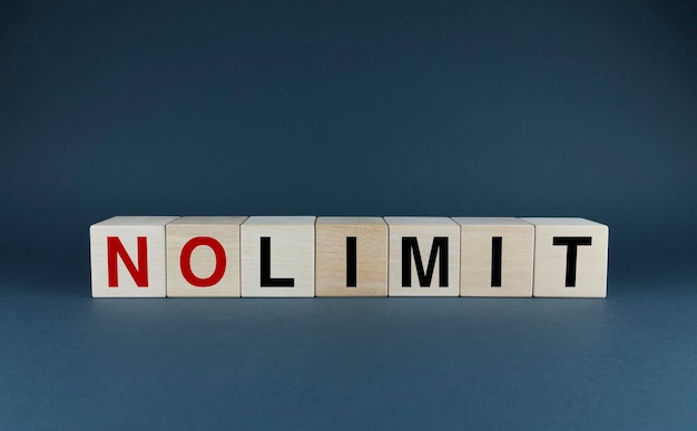 Photo no limit cubes form the word no limit the extensive concept of the word no limit