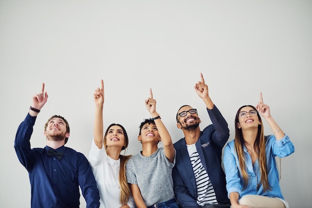 No matter how far it seems go after your dream Shot of a group of young people pointing towards something above them inside