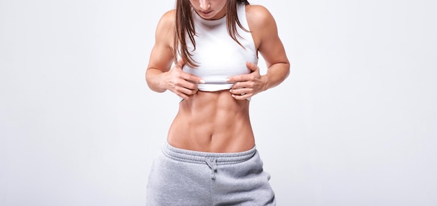 No name portrait young white fitness woman wearing sportswear\
standing over white wall background fitness concept