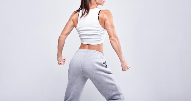 No name portrait young white fitness woman wearing sportswear\
standing over white wall background fitness concept
