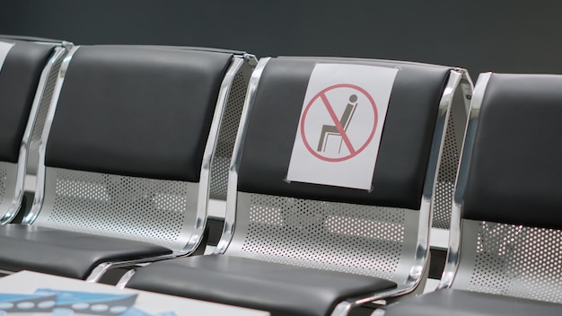 No people sitting on chairs in empty hospital reception area\
during coronavirus pandemic. nobody in waiting room at medical\
facility, healthcare service to help with covid 19 epidemic.