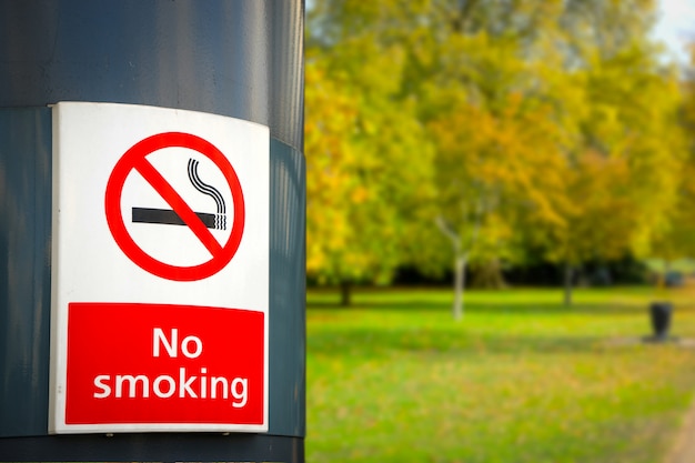 Не курить доска и знак в парке