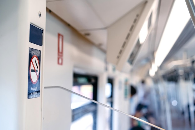 The No Smoking Sticker on the BTS train wall with blur background Texts on the sticker means No Smoking