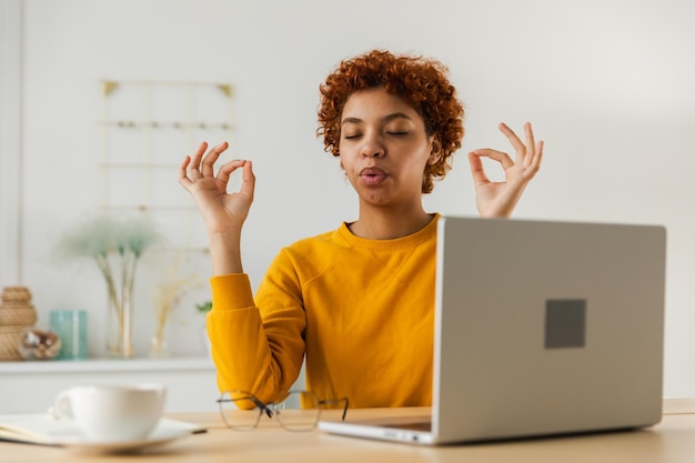 no stress keep calm mindful african businesswoman practices breathing exercises at home office