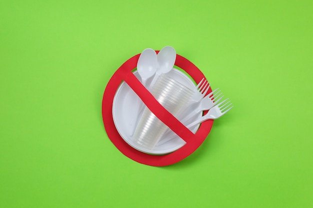 No use symbol in red forbidden sign with plastic dishes. Environmental concept.