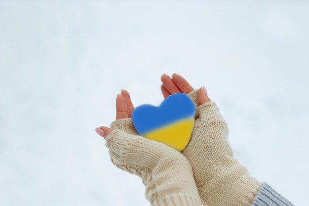 No war February the beginning of the war in Ukraine the girl holds a heart of a pathetic blue color in her hands Peace in Ukraine