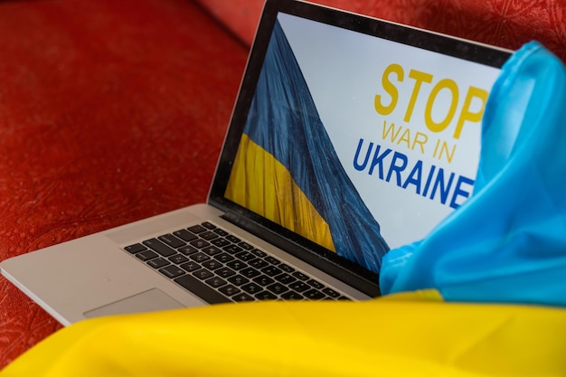 No war message on laptop. Ukraine vs Russia, conflict, cyber attack, invasion, army soldier. Hope for peace.