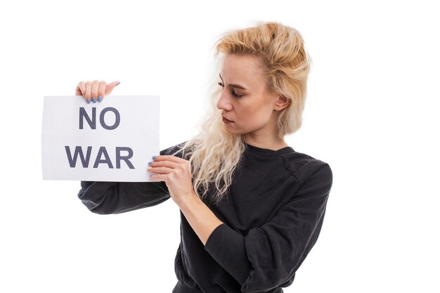 No war A young woman holds poster in her hands on a white background