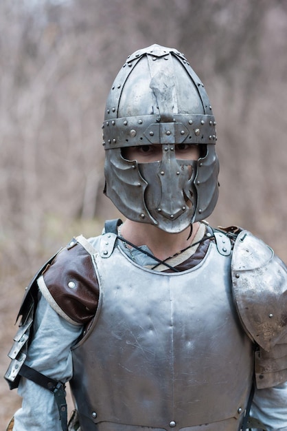 Noble warrior portrait of one medeival warrior or knight in\
armor and helmet with shield and sword posing