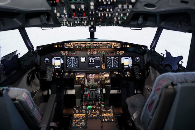 Nobody in empty captain cabin with dashboard navigation and engine throttle to fly airplane and travel. Cockpit with control panel command and power buttons, radar compass and windscreen.