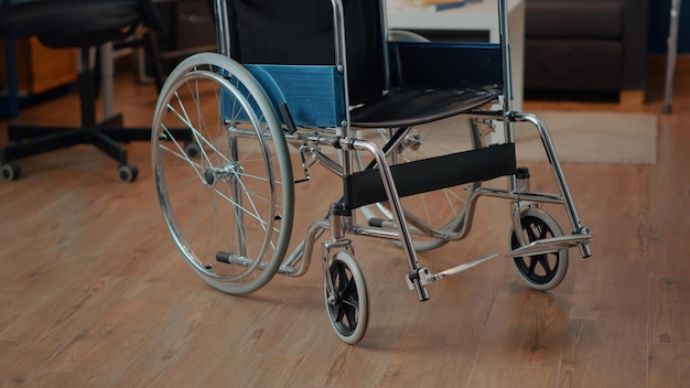 Nobody in living room with wheelchair to help with chronic\
disability. rehabilitation equipment to give transportation and\
mobility support to person with physical injury or impairment.