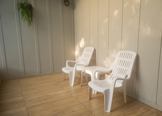 Nobody white chair around outdoor swimming pool in resort hotel empty