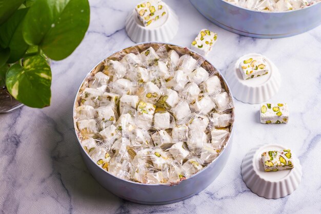 Noga sweet cube served in a dish isolated on grey background top view of desserts