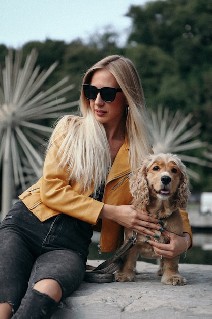 Noise and vintage style. Young girl with dog walks in the park and enjoys the beautiful summer day