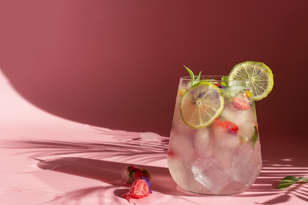 Non-alcoholic cocktail with frozen strawberries, mint and flowers.