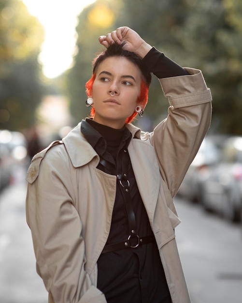 Non binary person with modern hairstyle outdoors