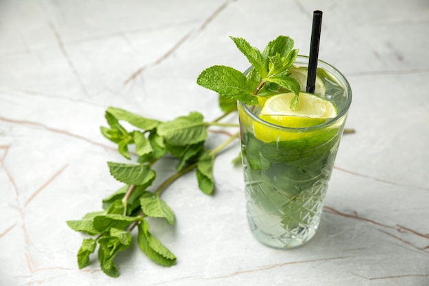 nonalcoholic cocktail lemonade With mint ice lime on a gray table