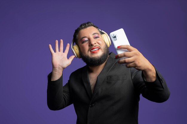 Nonbinary person on a video call with friends he is using his smartphone to talk with friends