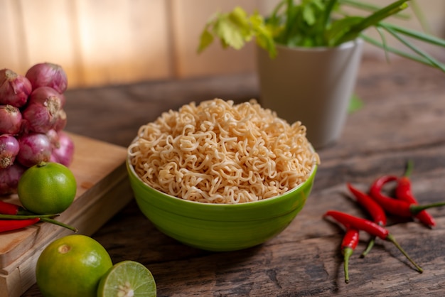 Noodle in a bowl with lime and chili and onion and vegetable