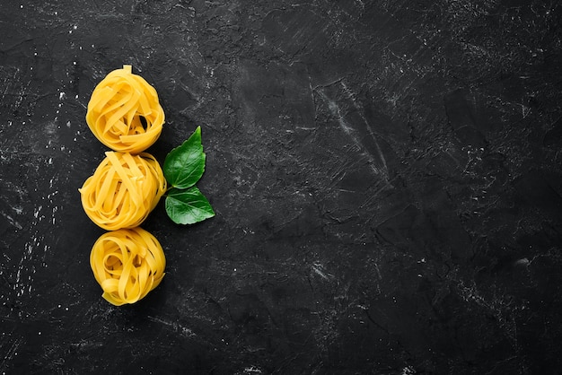 Tagliatelle pasta secca ingredienti del vecchio fondo vista dall'alto spazio libero per la copia