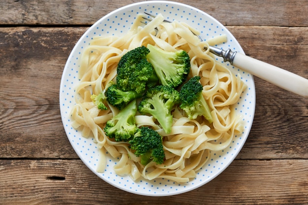 Noodles with boiled broccoli on a plate