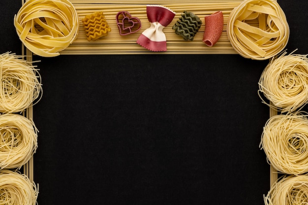 Noodles with pasta on a dark grey stone background