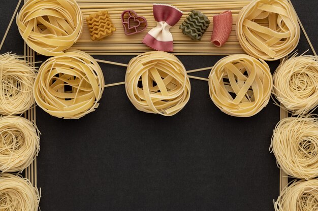 Noodles with pasta on a dark grey stone background