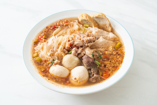 noodles with pork and meatballs in spicy soup or Tom yum noodles in Asian style