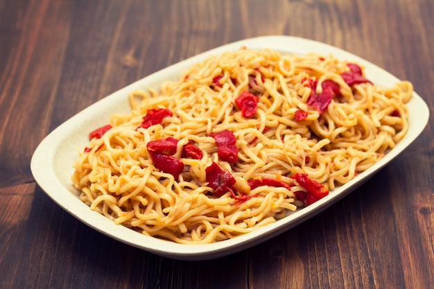 Noodles with vegetables on white dish